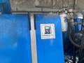 Close-up of a blue fuel tank on a 1997 Genie S-65 4X4 featuring a label that reads Unleaded Fuel Only
