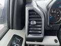 Interior dashboard of a 2017 Ford F-150 featuring a climate control air vent and instrument cluster with speedometer and gauges