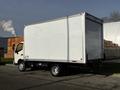 A 2015 Hino 195 box truck with a white cargo area and a grey cab parked with no visible markings on the side