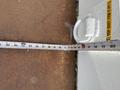A measuring tape extended from a point on a wall, showing measurements in inches, with visible markings indicating length