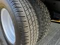 Close-up of a tire from a 2017 Ford Econoline showing a textured tread pattern and white rim