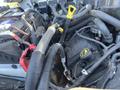 A 2016 Ford F-250 SD's engine compartment showing various hoses connectors and a battery with red and black cables