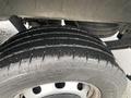 A close-up view of a wet tire on a 2018 Ford Transit showcasing the tread pattern and rim details