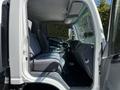 The interior of a 2007 GMC W3500 featuring two gray seats a steering wheel and dashboard elements visible in the cabin space