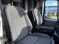 Two gray fabric seats from a 2017 Ford Transit van with a simple design and armrests