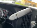Close-up of a control stalk with a plus and minus button on a 2013 Chevrolet Express dashboard