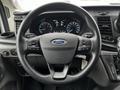 A 2021 Ford Transit steering wheel with control buttons and the Ford logo visible at the center