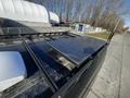 A 2017 Ford Transit with a solar panel mounted on its roof