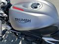 A 2018 Triumph Street Triple RS motorcycle featuring a silver fuel tank with the Triumph logo in black and a circular fuel cap on top