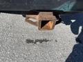 Close-up of a rusty hitch receiver on a 2016 Ford F-250 SD with visible wear and corrosion on the metal surface