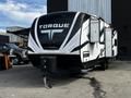 A 2022 Heartland Torque travel trailer featuring a sleek black and white design with the word "TORQUE" prominently displayed on the front