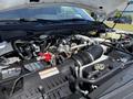 Close-up view of the engine compartment of a 2023 Ford F-550 showcasing the various components including hoses wires and the engine block