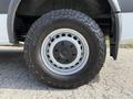 Close-up of a wheel and tire on a 2017 Mercedes-Benz Sprinter showing the silver rim and rugged black tire tread