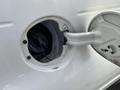Fuel filler cap open on a 2005 Chrysler PT Cruiser with the fuel nozzle inserted
