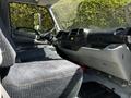 Interior of a 2018 Hino 195 showing the driver’s seat dashboard and controls with gray upholstery and features designed for utility and convenience