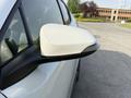 Close-up of the side mirror of a 2021 Toyota C-HR showcasing its sleek design and white color
