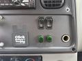 Interior controls of a 2005 Freightliner M2 106 including switches for various functions and a sticker that reads Click Before You Dig