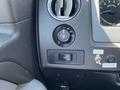 Dashboard controls of a 2014 Ford F-150 including dial for lighting and switch for additional features