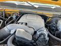 A close-up view of the engine compartment of a 2013 Chevrolet Silverado 1500 showing the engine and various components