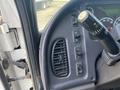 Control panel with buttons and a gear shift lever inside a 2017 Freightliner M2 106 truck cabin