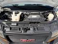 A 2019 GMC Savana's engine bay showcasing the engine components and various fluid reservoirs