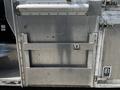 A silver aluminum panel with brackets and a latch, part of a 2008 Morgan Olson Workhorse vehicle, showcasing its commercial design and sturdy construction
