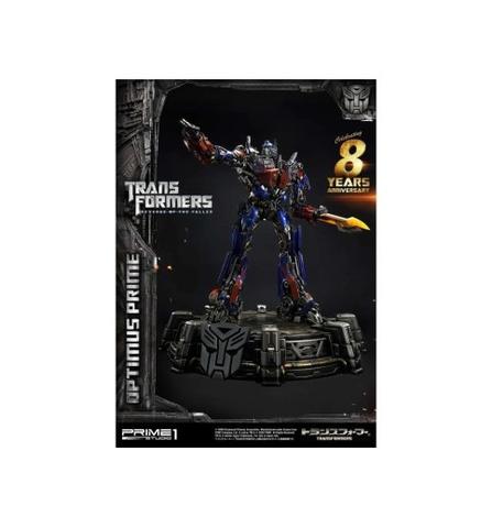 A Transformers Revenge of the Fallen Museum Masterline Optimus Prime EX Bonus Ver statue in an action pose with a raised arm holding a weapon on a detailed base