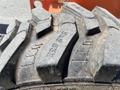 Close-up of a large, rugged tire from a 2008 JLG Boom Lift showing deep treads and side markings designed for traction on construction sites