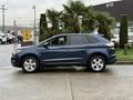 A 2017 Ford Edge in a blue color is displayed from the side with five-spoke alloy wheels and a sleek design
