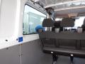 Interior view of a 2016 Mercedes-Benz Sprinter van showing black seating and part of the cargo area