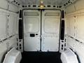 Interior of a 2021 RAM Promaster van featuring bare white walls and empty seating on either side with large double doors at the back