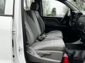 Interior view of a 2018 GMC Sierra 1500 showing the front passenger and driver's seats with gray upholstery and a fire extinguisher on the floor by the front console