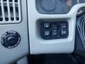 Control panel of a 2014 International Durastar featuring buttons for mirror adjustments panel lights and other controls