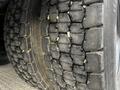 Close-up view of a worn tire on a 2013 International 4200 showing rough tread with visible debris embedded in the grooves