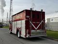 Red 1994 Freightliner FL80 fire department rescue vehicle with reflective markings and emergency lighting