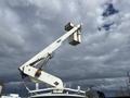 A 2008 Ford Econoline with an extended white bucket arm for elevated work operations