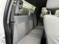 Interior view of a 2013 Ford F-350 SD showing the rear bench seat with gray fabric upholstery and headrest mountings