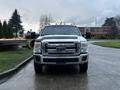 A 2014 Ford F-350 SD pickup truck is parked facing forward with chrome accents and a distinctive front grille