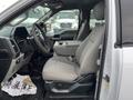 Interior of a 2017 Ford F-150 showing the driver's seat and console with gray fabric upholstery and a clean design