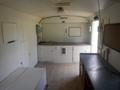 Interior of a 2004 Royal 18 Foot Office Trailer featuring a counter space a small window and storage areas along the walls