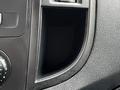 Image shows the interior of a 2020 Mercedes-Benz Metris with a focus on a black plastic compartment or cup holder without any items inside