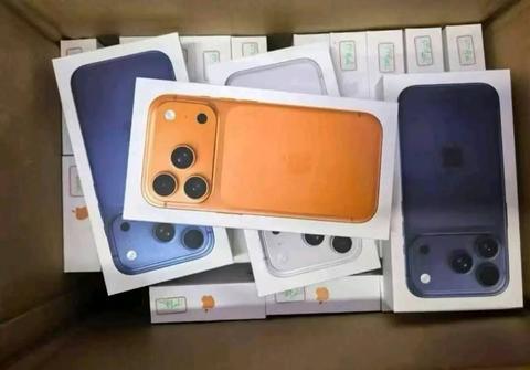 iPhone 17 Pro Max 1TB in orange color displayed on packaging with three camera lenses visible on the back