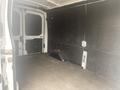 Interior of a 2024 Ford Transit van featuring a spacious cargo area with a flat floor and side walls that are lined with dark panels