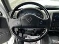 Steering wheel and dashboard of a 2017 International WorkStar 7600 displaying gauges and controls