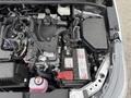 A close-up view of the engine compartment of a 2025 Toyota Corolla showing various components including the battery and electrical systems