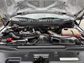 Engine compartment of a 2018 Ford F-550 with visible components like the air intake pipe hoses and coolant reservoir