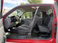 Red 2013 Chevrolet Silverado 3500HD interior showing the front and rear seats with a spacious cabin layout and a steering wheel in the front seat