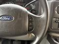 Close-up of a Ford steering wheel showing control buttons for cruise control and an airbag emblem