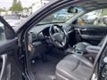 Interior of a 2015 Kia Sorento showing the steering wheel dashboard and front seats with a gear shift in the center console