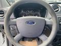 Steering wheel of a 2013 Ford Transit Connect with the Ford logo and dashboard gauges visible in the background